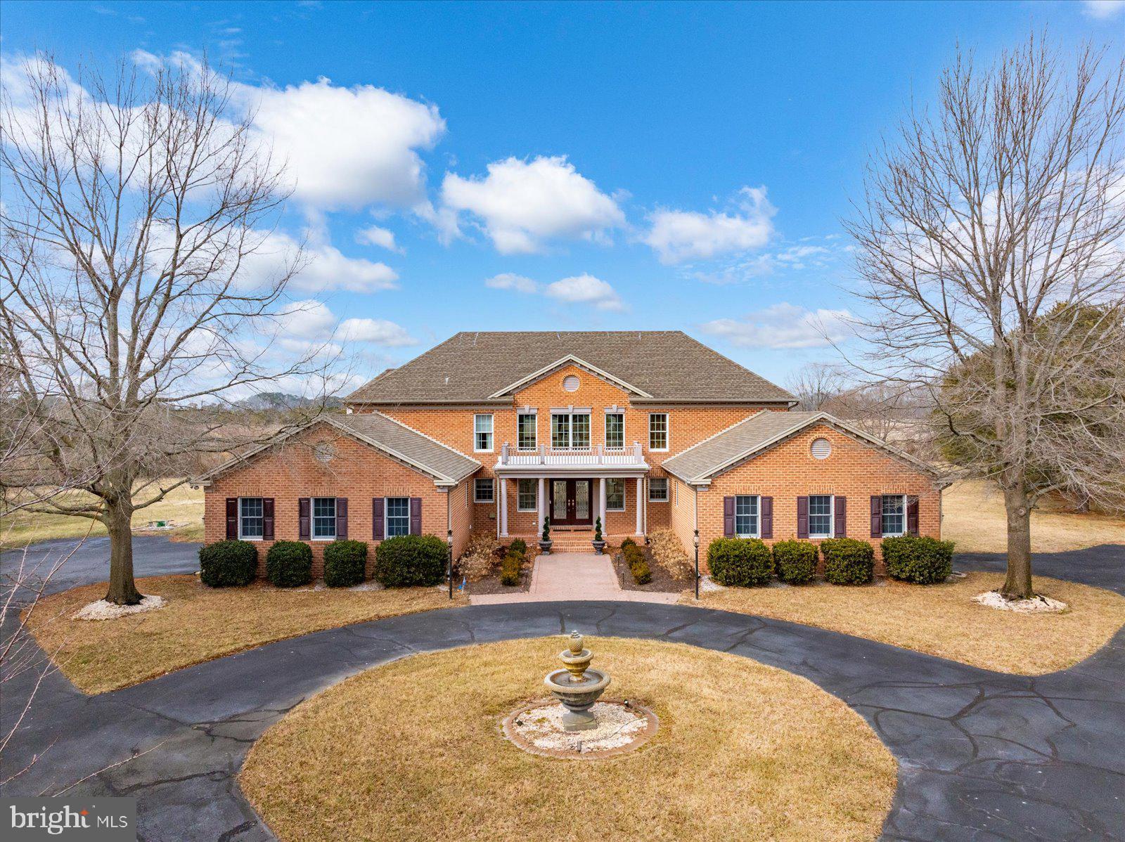 a front view of a house with yard swimming pool and outdoor seating