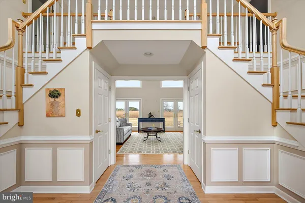 a kitchen with stainless steel appliances granite countertop a refrigerator a stove and a wooden floors