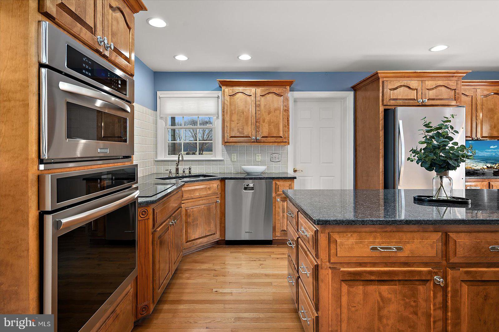 12661 Mallard Landing Road Princess Anne, MD 21853 - Photo 14 of 123 a kitchen with stainless steel appliances granite countertop a stove a sink and a microwave