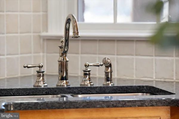 a dining room with furniture a chandelier and wooden floor