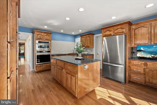 a dining room with furniture a fireplace and wooden floor