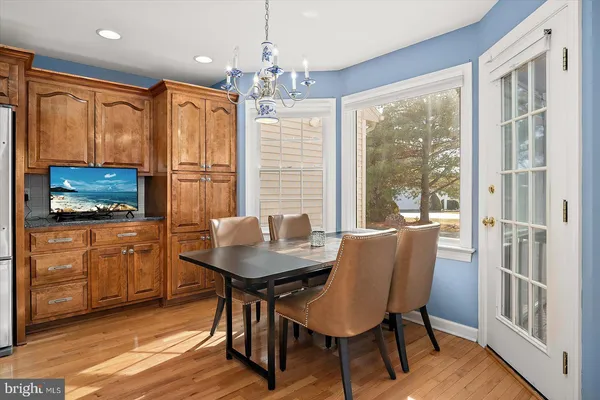 a view of a dining room with furniture and a chandelier