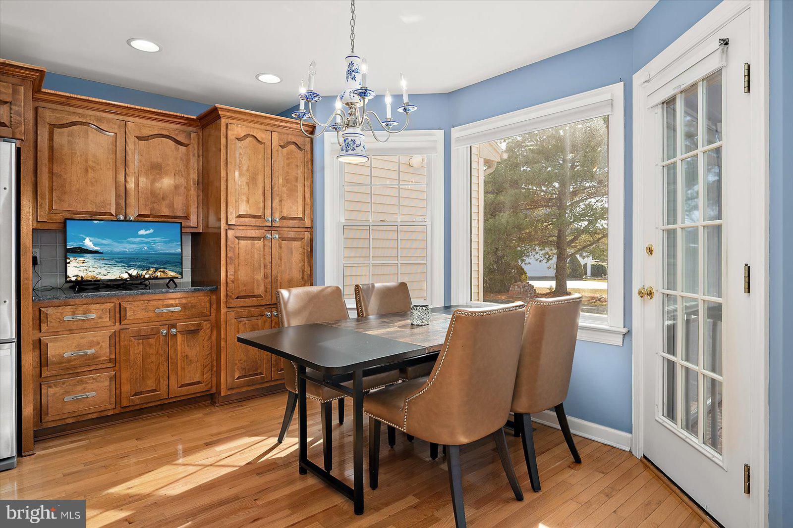 12661 Mallard Landing Road Princess Anne, MD 21853 - Photo 26 of 123 a dining room with furniture a window and wooden floor