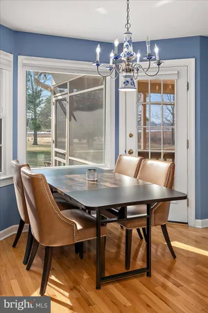 a view of a dining room with furniture and a chandelier