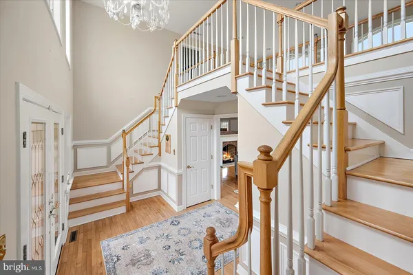 a view of entryway with wooden floor and front door