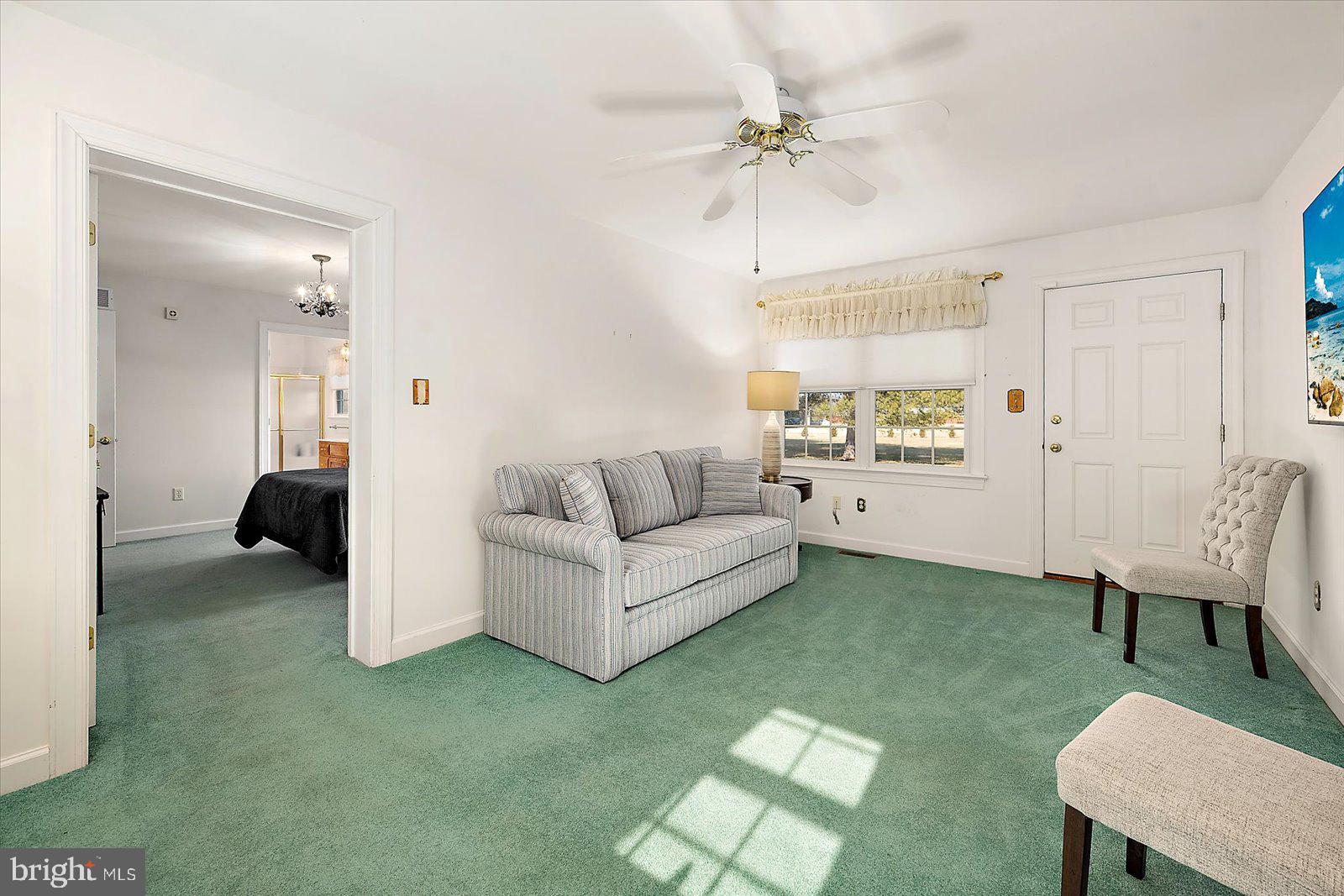 12661 Mallard Landing Road Princess Anne, MD 21853 - Photo 67 of 123 a living room with furniture and a chandelier