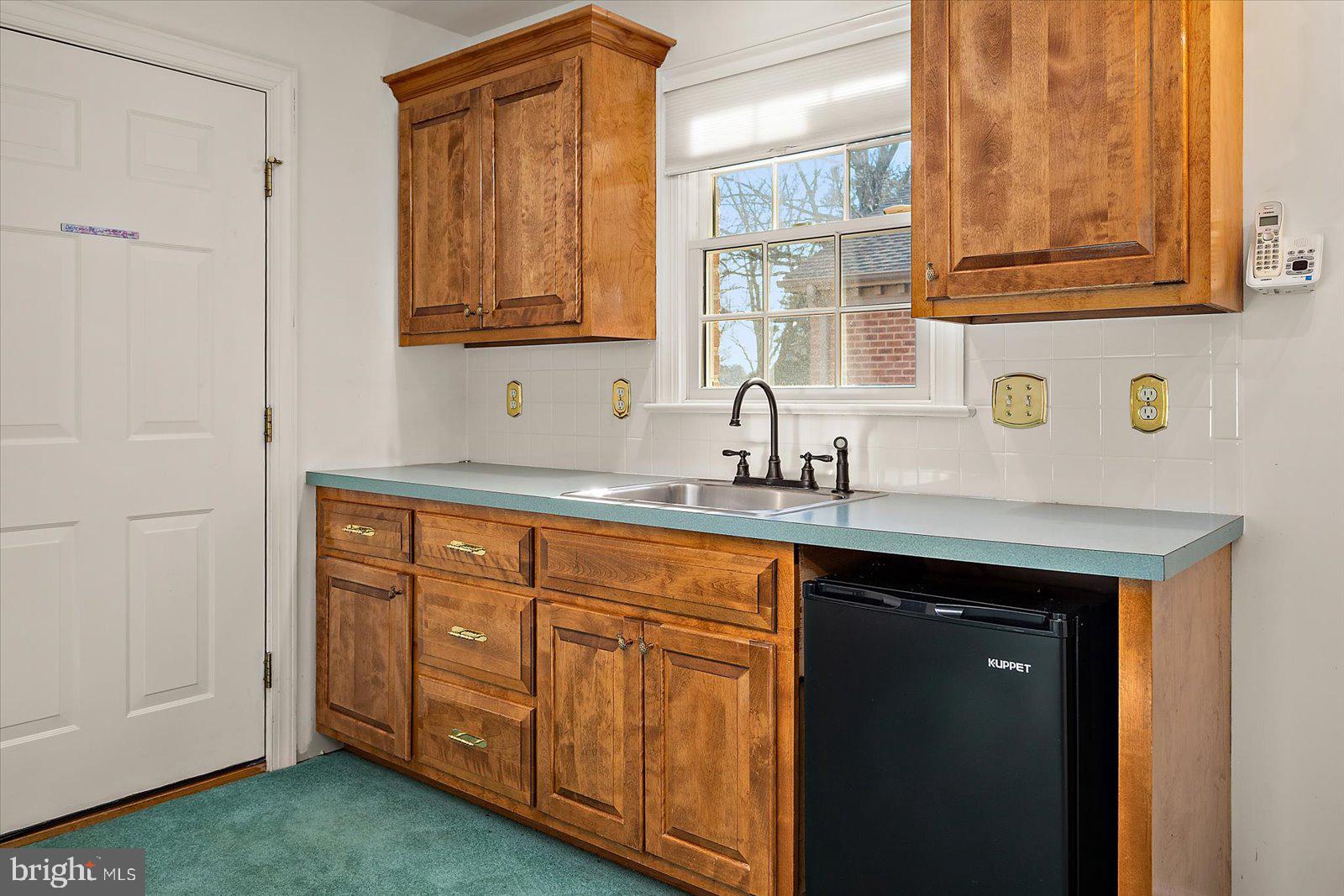 12661 Mallard Landing Road Princess Anne, MD 21853 - Photo 70 of 123 a kitchen with stainless steel appliances granite countertop a sink and dishwasher with wooden cabinets