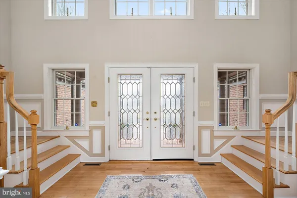 a view of entryway with wooden floor and windows