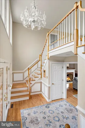 a view of entryway bedroom and hall with wooden floor
