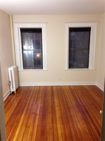 46 Orkney Road, Unit 1 Boston, MA 02135 - Photo 5 of 12 a view of an empty room with wooden floor and a window