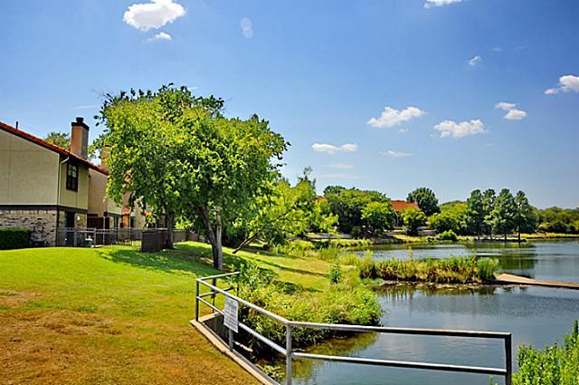 2610 Lakehill Lane, Unit 6B Carrollton, TX 75006 - Photo 3 of 18 a view of a lake with a house in the background