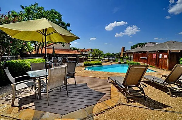 a view of a chairs and table in the patio with a fire pit