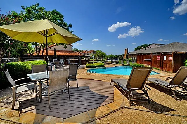 a view of a chairs and table in the patio with a fire pit