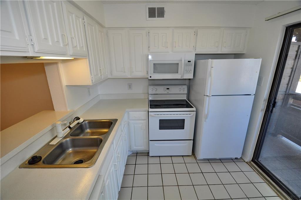 2610 Lakehill Lane, Unit 6B Carrollton, TX 75006 - Photo 7 of 18 a kitchen with a refrigerator sink and stove