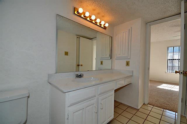 2610 Lakehill Lane, Unit 6B Carrollton, TX 75006 - Photo 8 of 18 a bathroom with a sink and a mirror