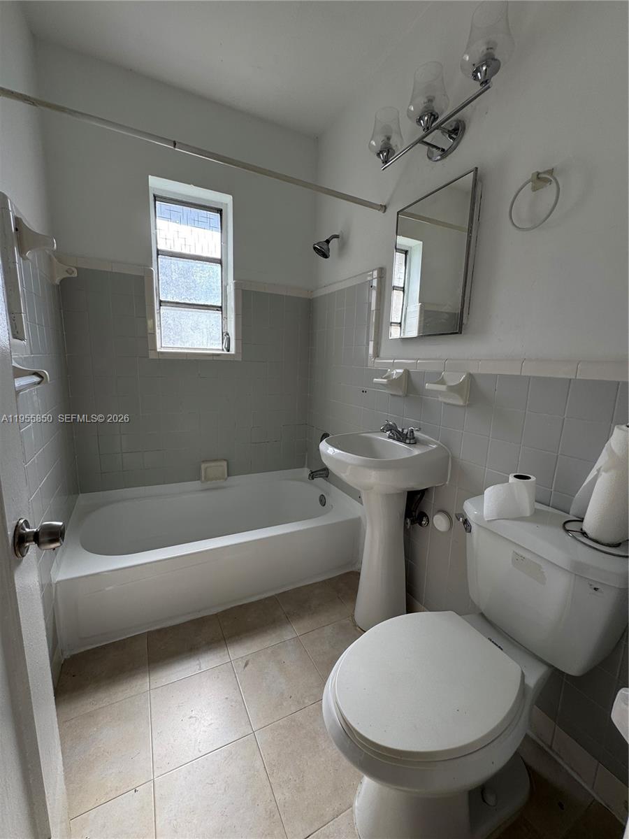 1431 Southwest 37th Avenue, Unit 4 Miami, FL 33145 - Photo 11 of 19 a bathroom with a toilet sink and mirror