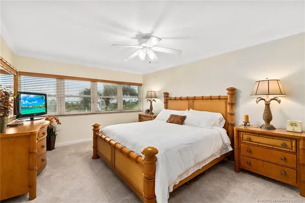 a bedroom with a bed and a balcony view