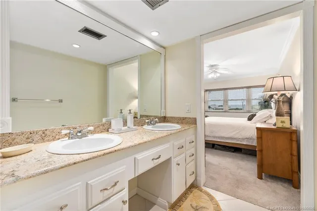 a spacious bathroom with a granite countertop sink and a mirror