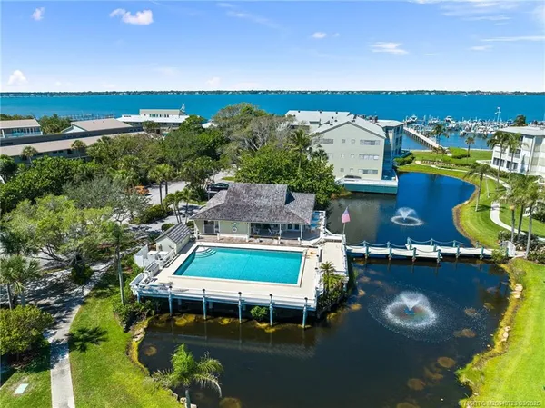an aerial view of a house with swimming pool outdoor seating and yard
