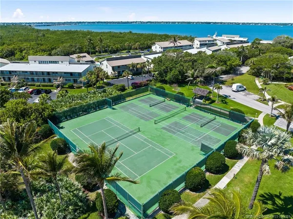 a view of a tennis ground with a mountain view