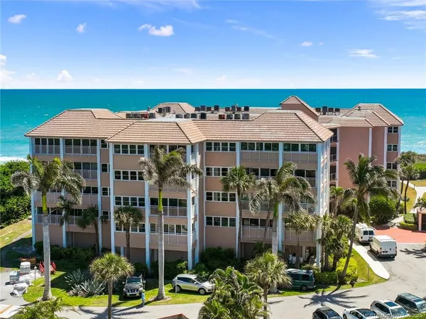 a view of a large building with a garden and plants