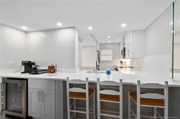 a kitchen with granite countertop a sink and cabinets
