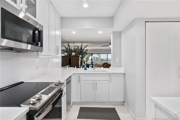 a kitchen with a sink stainless steel appliances and cabinets