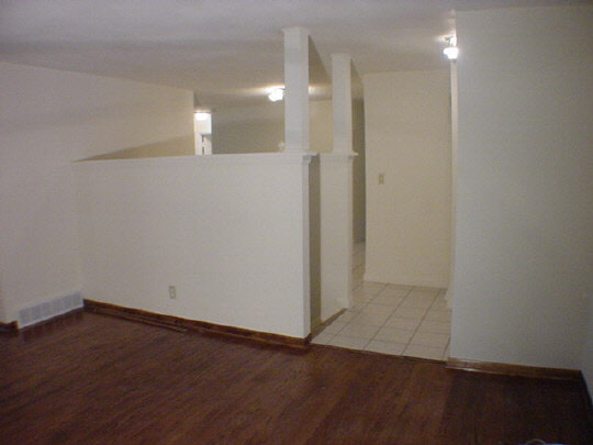 5016 Highcrest Road Rockford, IL 61107 - Photo 2 of 6 an empty room with wooden floor and windows