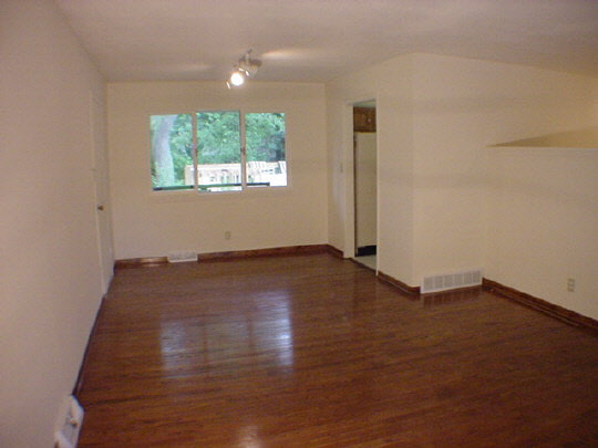 5016 Highcrest Road Rockford, IL 61107 - Photo 3 of 6 an empty room with wooden floor and windows