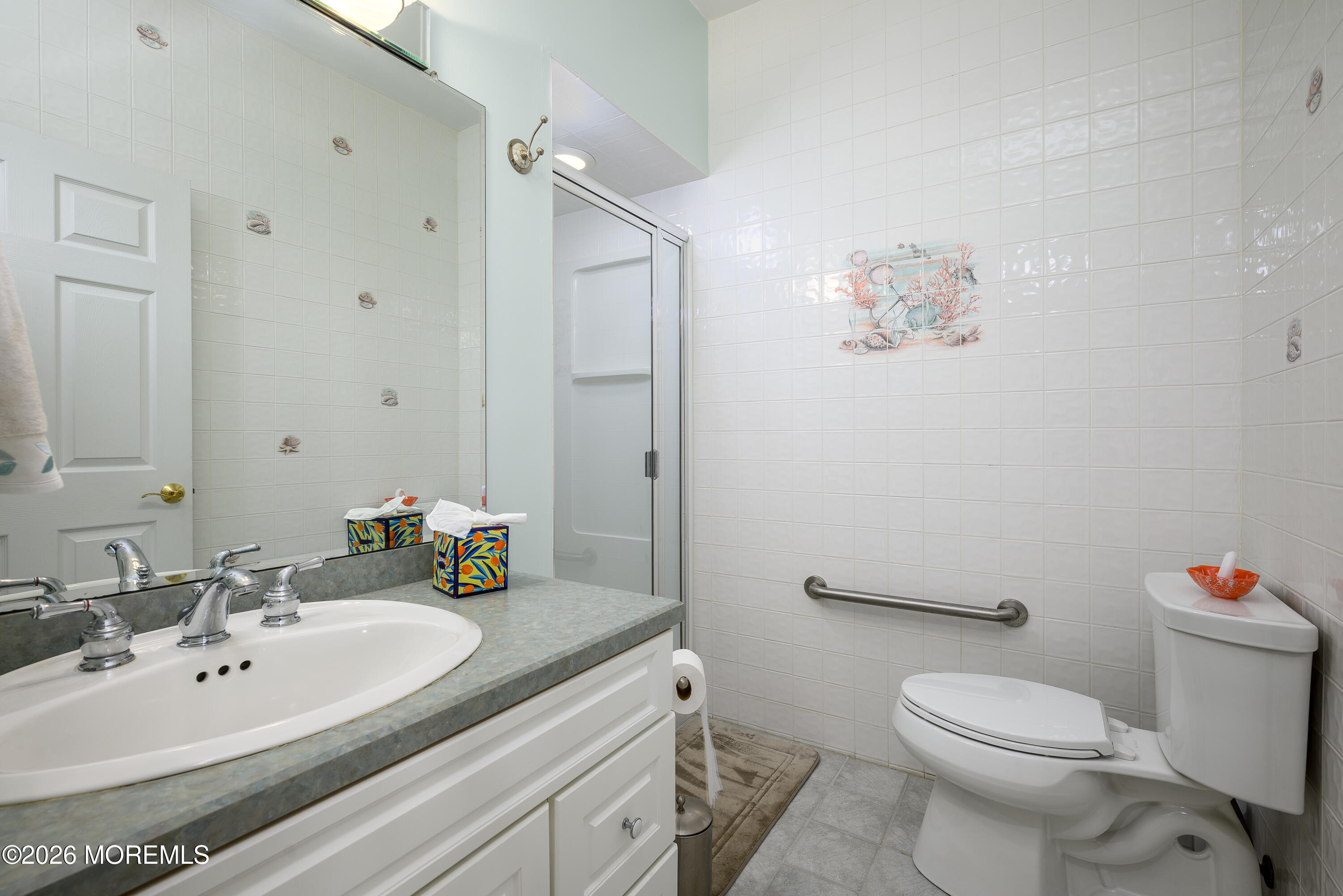 805 Front Street Union Beach, NJ 07735 - Photo 18 of 65 a bathroom with a sink mirror vanity and toilet