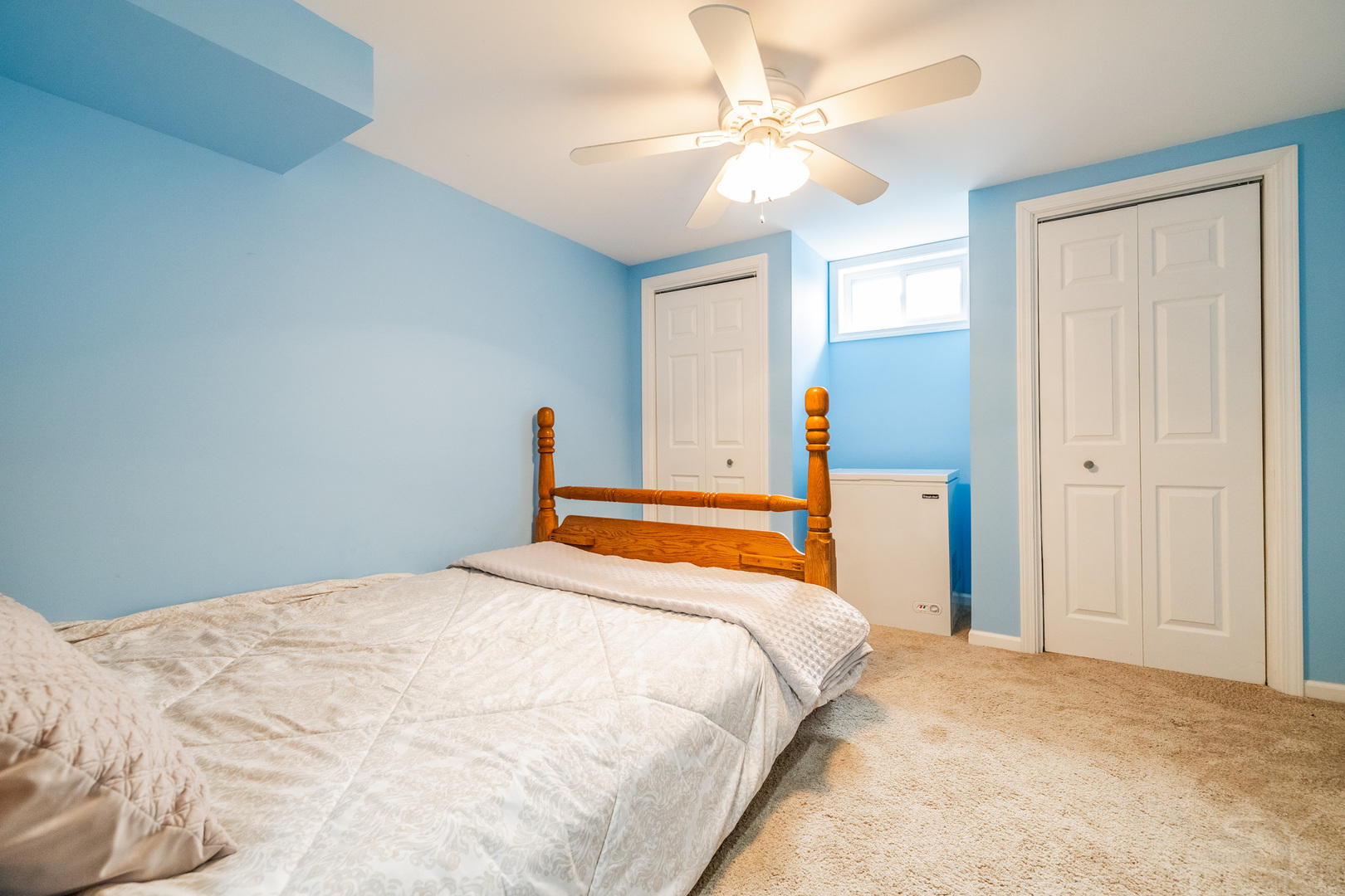 8001 William Drive Willowbrook, IL 60527 - Photo 38 of 73 a bedroom with a large bed and a chandelier