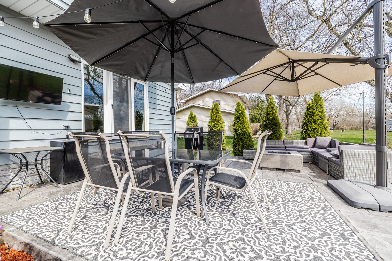 8001 William Drive Willowbrook, IL 60527 - Photo 53 of 73 a view of a patio with a table and chairs under an umbrella