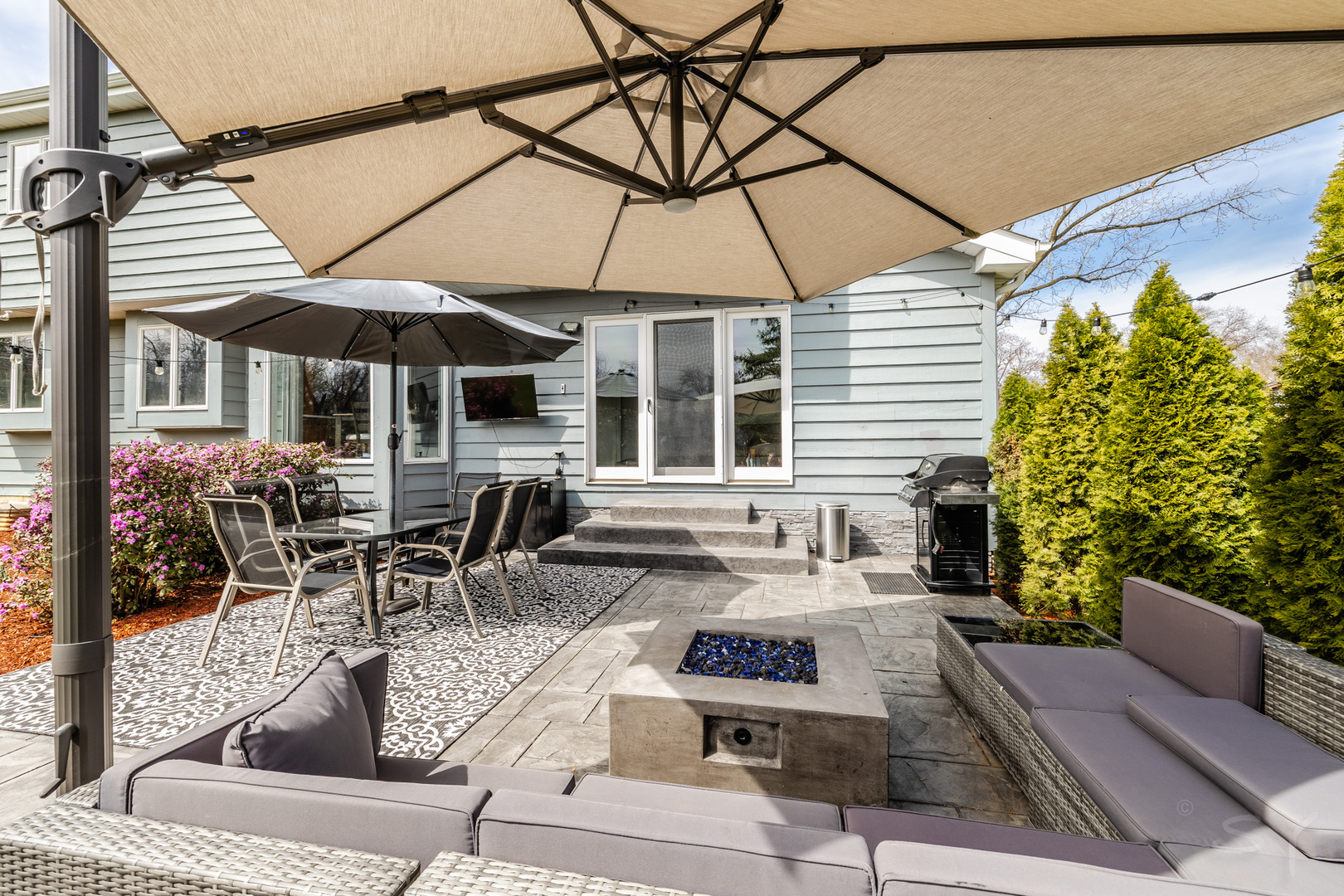 8001 William Drive Willowbrook, IL 60527 - Photo 58 of 73 a view of a patio with couches table and chairs under an umbrella