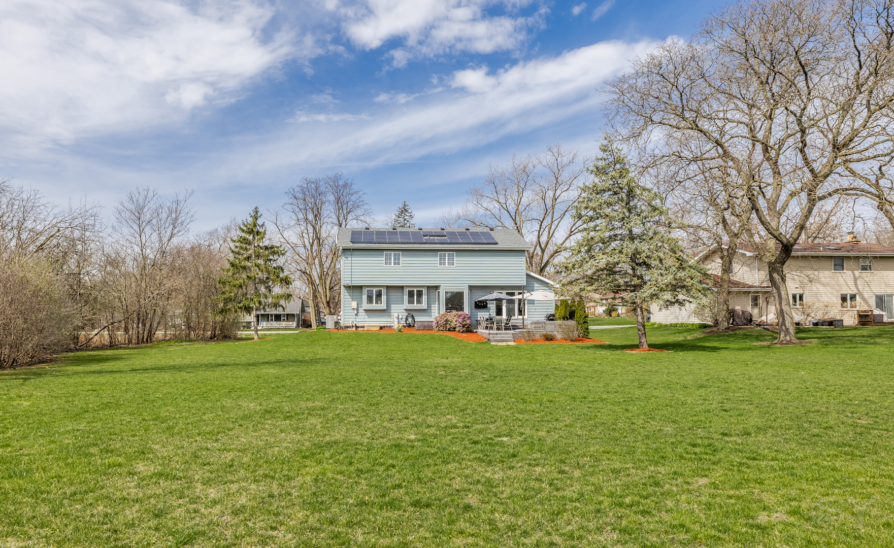 8001 William Drive Willowbrook, IL 60527 - Photo 65 of 73 a view of a white house in front of a big yard with plants and large trees