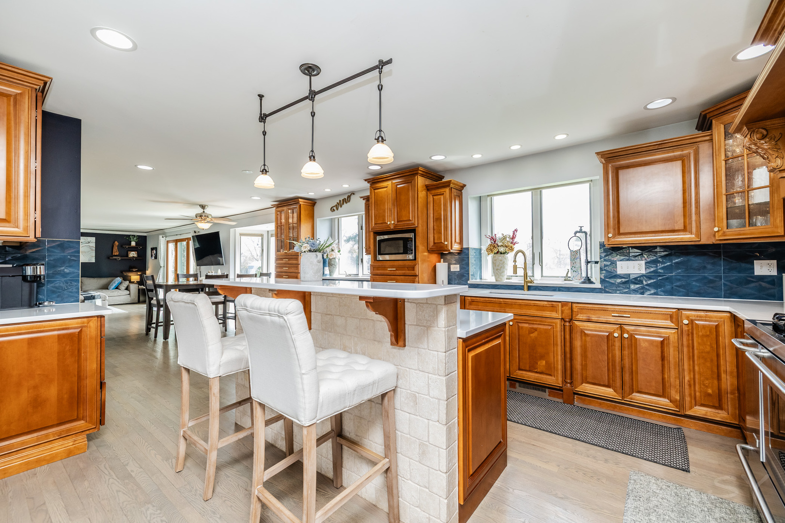 8001 William Drive Willowbrook, IL 60527 - Photo 8 of 73 a kitchen with stainless steel appliances granite countertop a kitchen island a stove a sink a dining table and chairs with wooden floor