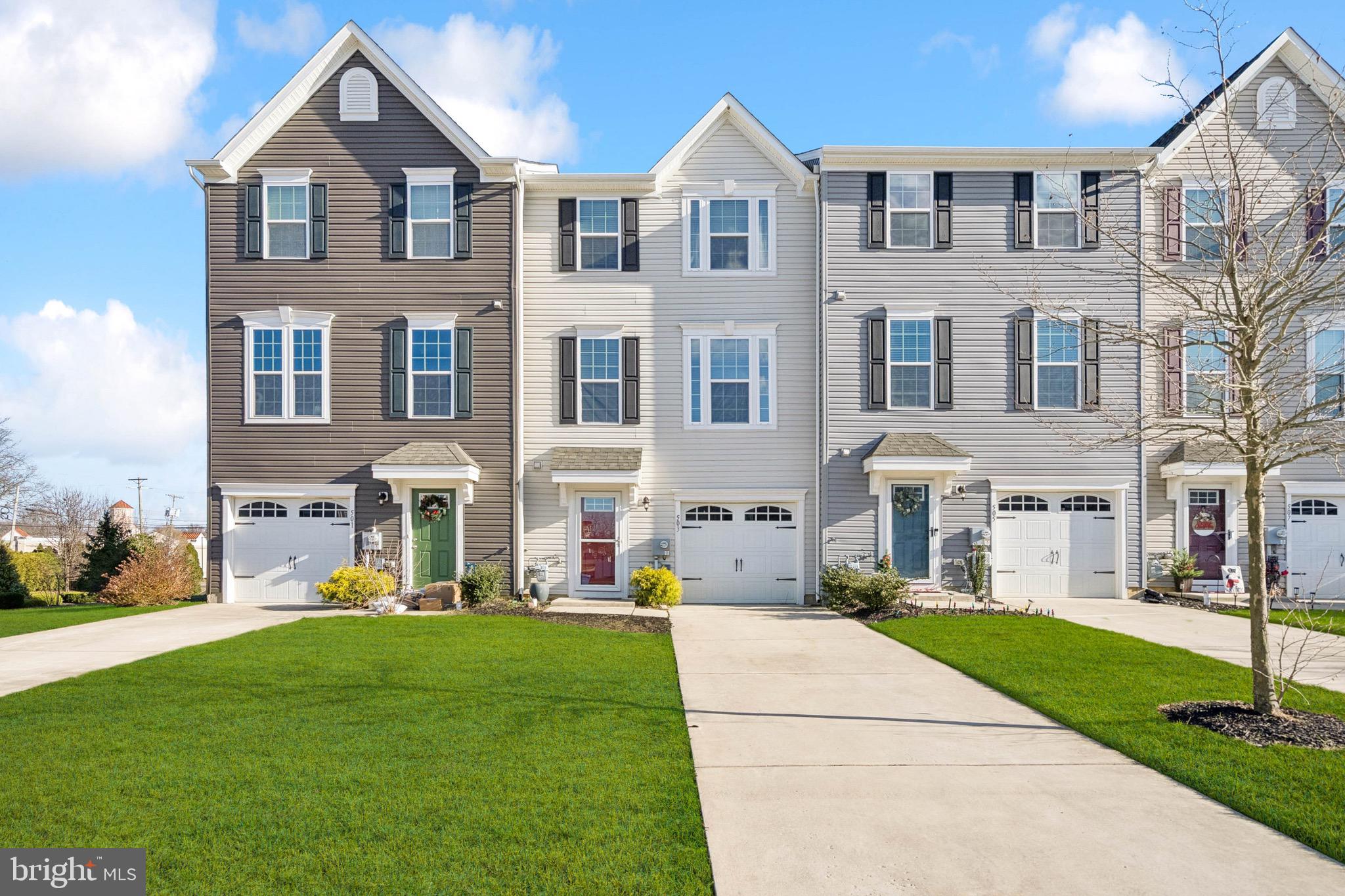 a front view of a residential apartment building with a yard