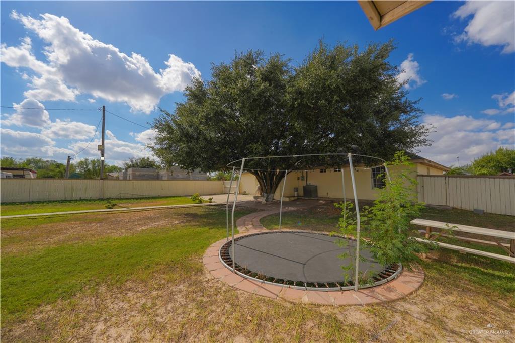 6112 Davis Lane Mission, TX 78574 - Photo 18 of 23 a view of a swimming pool with a yard