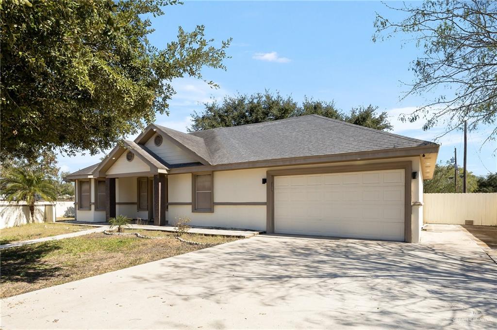6112 Davis Lane Mission, TX 78574 - Photo 2 of 23 a front view of a house with a yard and garage