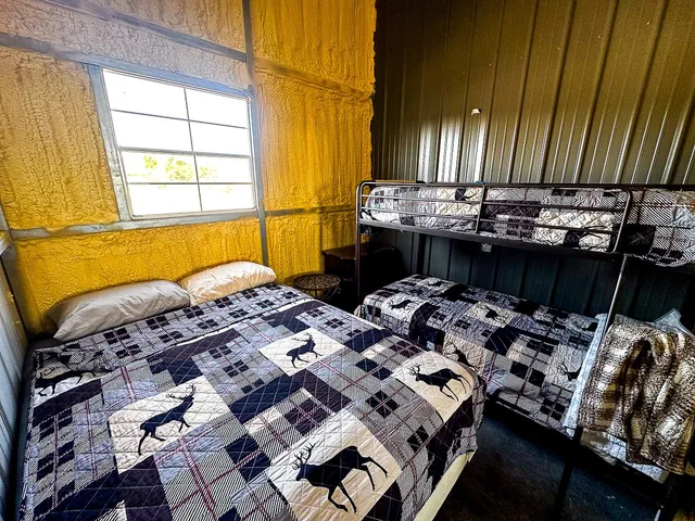 a bed sitting in a bedroom next to a window