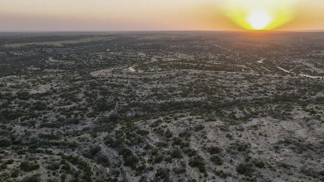 an aerial view of house with yard and mountain view in back