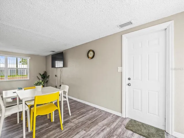 a view of a dining room with furniture and wooden floor