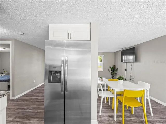 a kitchen with a refrigerator and cabinets