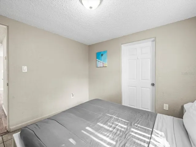 a bathroom with a granite countertop sink a toilet and a bathtub