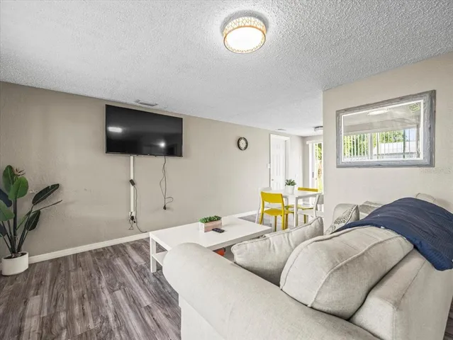 a spacious bedroom with a bed and a flat screen tv