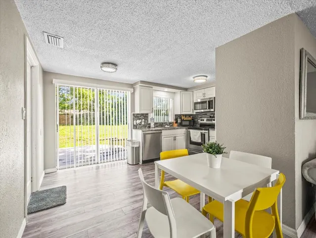 a view of a dining room with furniture and wooden floor
