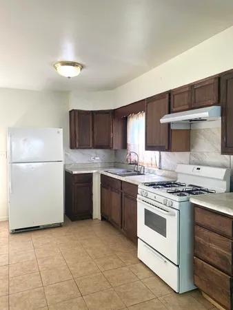 a kitchen with a stove top oven sink and cabinets