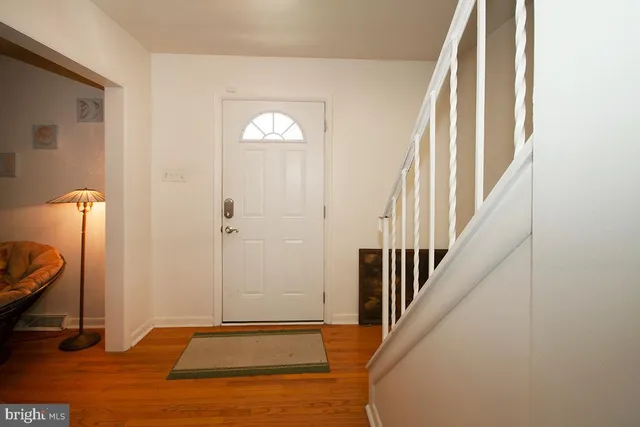 a view of an entryway with wooden floor