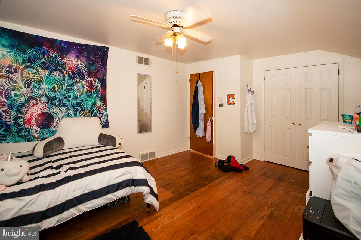 316 Swarthmore Road Glassboro, NJ 08028 - Photo 17 of 30 a bedroom with a bed and a chandelier