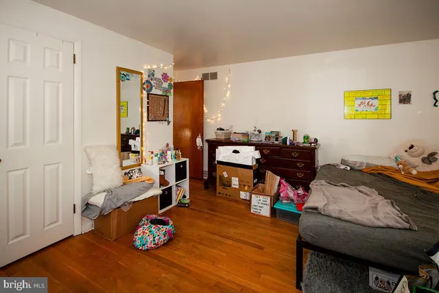 a bedroom with furniture and a wooden floor