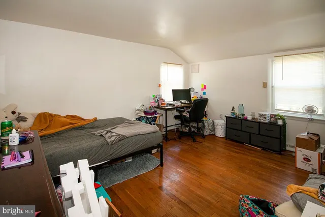 a bedroom with furniture and a wooden floor